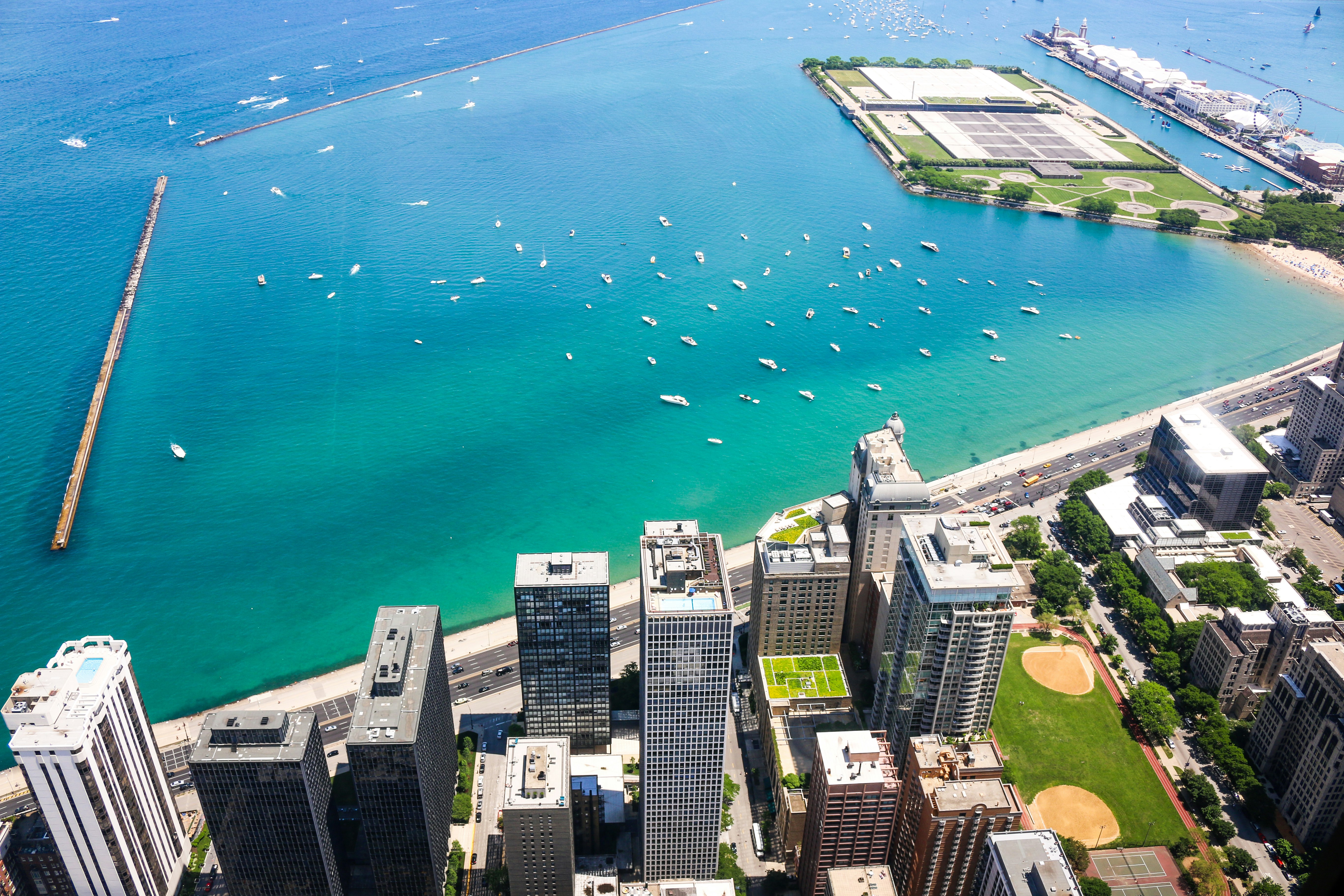 aerial photo of cityscape beside teal calm body of water at daytime